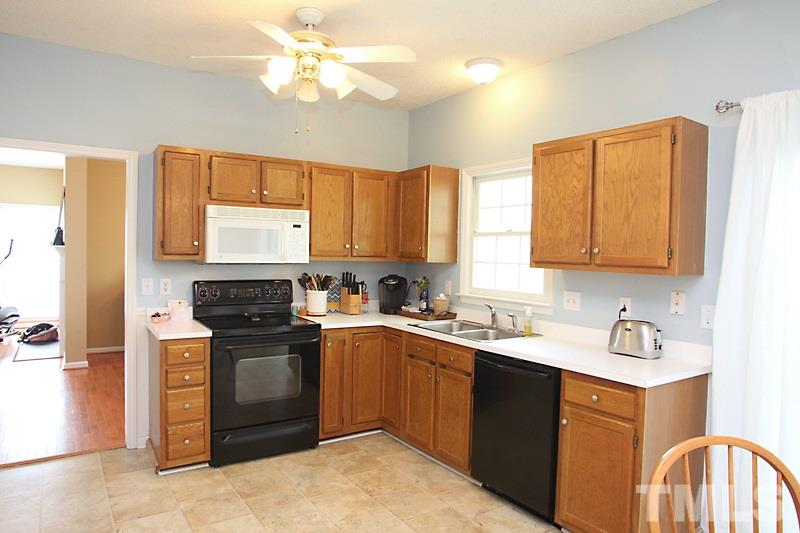5501 Edgebury Road Raleigh, NC 27613 - Photo 5 of 14 a kitchen with stainless steel appliances granite countertop a sink a stove cabinets counter space and a window