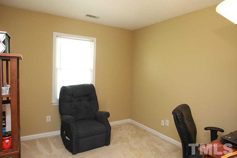 5501 Edgebury Road Raleigh, NC 27613 - Photo 7 of 14 a blue chair sitting next to a blue wall