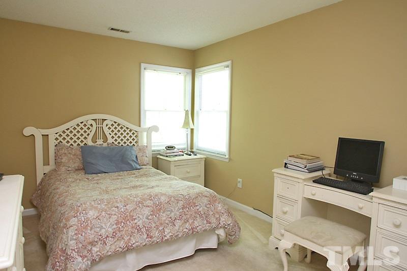 5501 Edgebury Road Raleigh, NC 27613 - Photo 8 of 14 a bedroom with a bed and a window