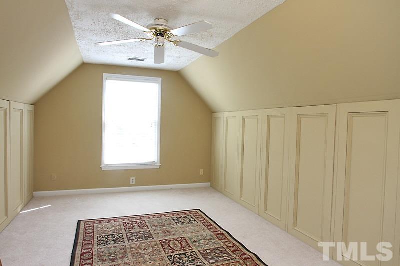 5501 Edgebury Road Raleigh, NC 27613 - Photo 9 of 14 a bathroom with a window and a chandelier