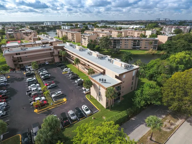 an aerial view of a house with a garden and lake view