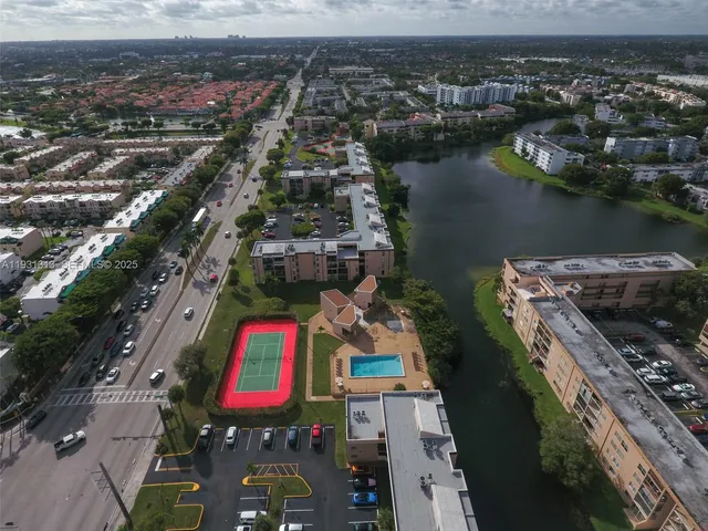 an aerial view of residential houses with outdoor space and lake view