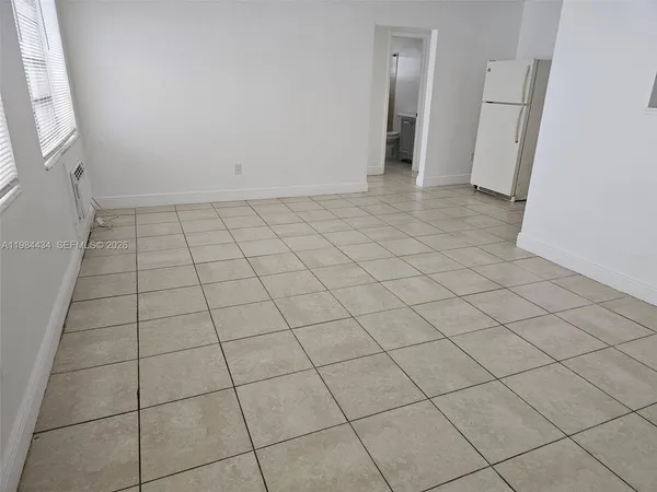 an empty room with a empty space and a window