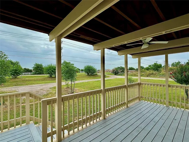 a view of a balcony with wooden floor