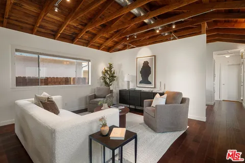 a kitchen with appliances cabinets and wooden floor