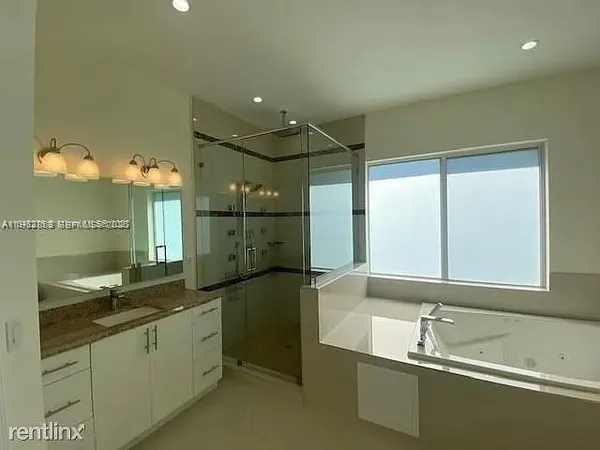 a bathroom with a sink and a large mirror