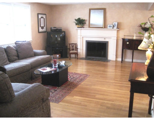 27 Gilbert Road Needham, MA 02492 - Photo 2 of 10 a living room with furniture and a fireplace