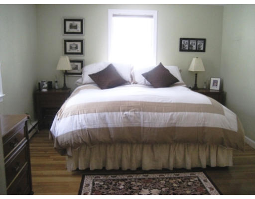 27 Gilbert Road Needham, MA 02492 - Photo 6 of 10 a bedroom with a bed and a painting on the wall