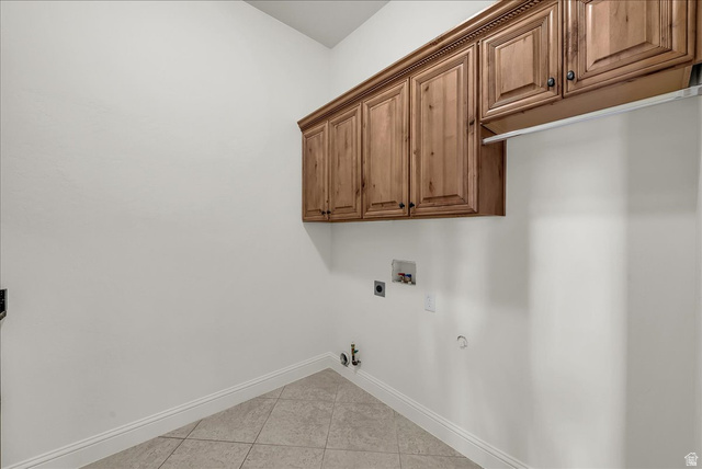 691 Rainier Drive St. George, UT 84770 - Photo 15 of 24 Laundry room with gas dryer hookup, light tile patterned floors, cabinet space, washer hookup, and hookup for an electric dryer
