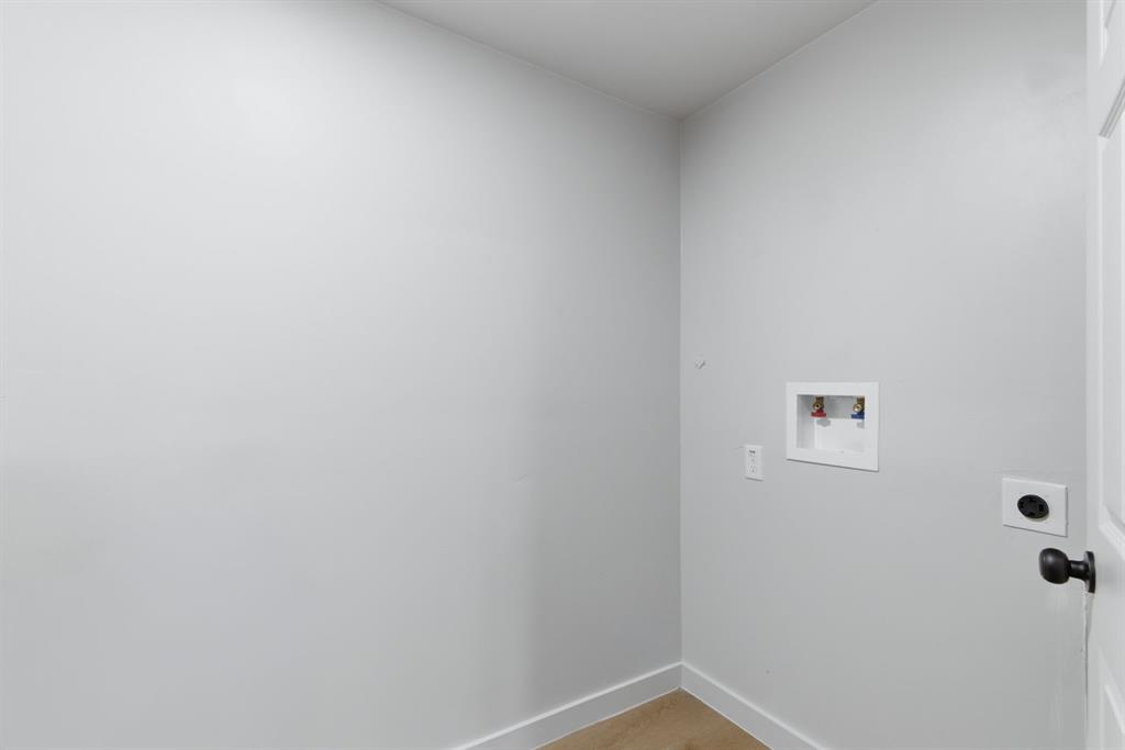 507 Country Club Road Cleburne, TX 76033 - Photo 31 of 39 Dedicated utility space featuring a washing machine hookup, neutral wall color, and clean baseboards
