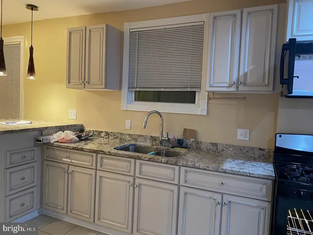 a kitchen with stainless steel appliances granite countertop a sink and cabinets