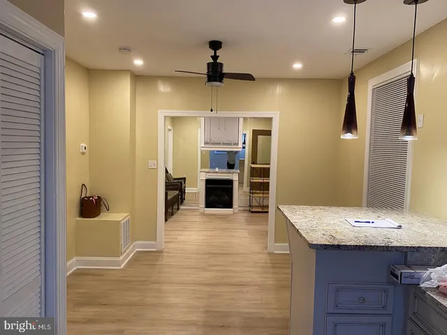 a view of a kitchen with a sink and a refrigerator wooden floor