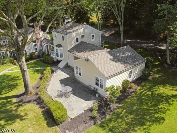 an aerial view of a house with a yard