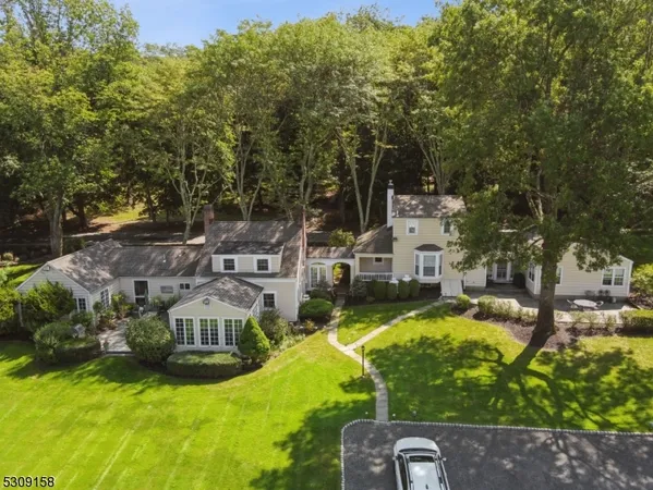a view of a house with swimming pool and a yard