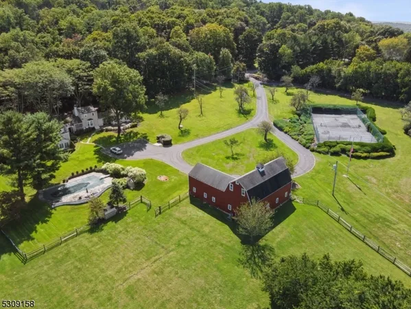 an aerial view of a house with a garden and swimming pool
