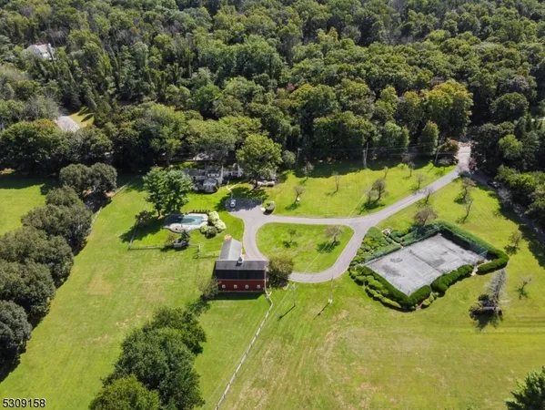 an aerial view of a house with yard swimming pool and outdoor seating