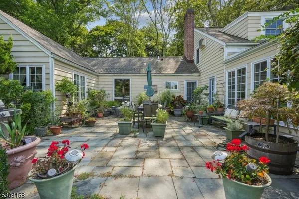 a view of a house with a backyard and sitting area