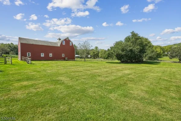 a view of a field of grass and a building