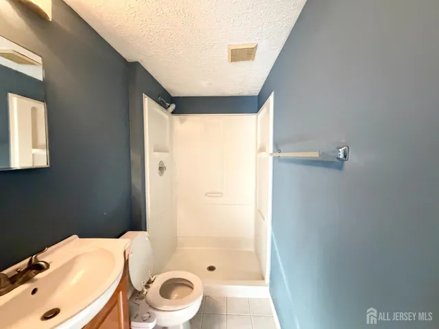 a bathroom with a sink a toilet and shower curtain