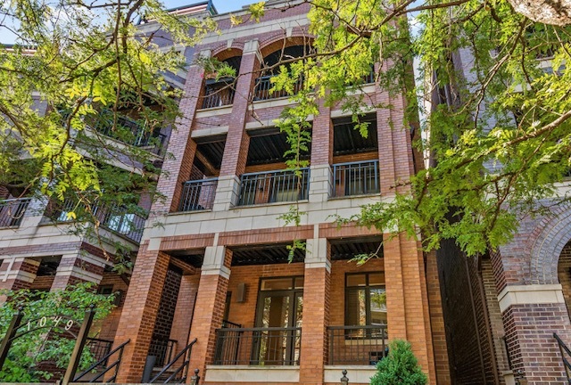 front view of a house with a tree