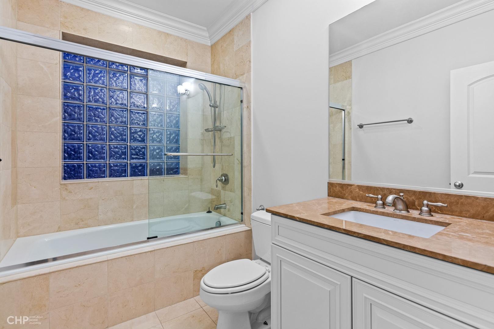 1049 West Monroe Street, Unit 1 Chicago, IL 60607 - Photo 18 of 22 a bathroom with a sink a toilet and shower