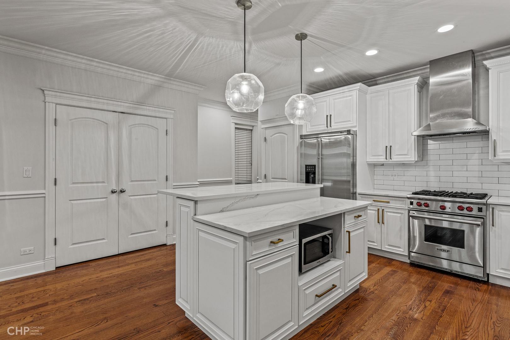 1049 West Monroe Street, Unit 1 Chicago, IL 60607 - Photo 8 of 22 a kitchen with stainless steel appliances granite countertop a stove a sink and a refrigerator