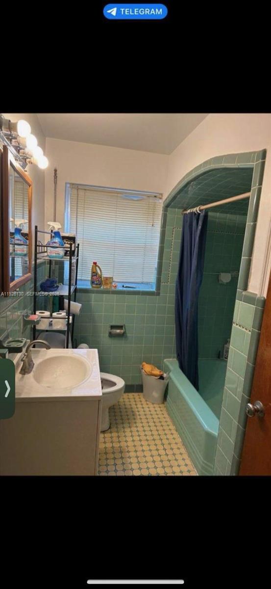 1843 Wiley Street, Unit 2 Hollywood, FL 33020 - Photo 15 of 15 a view of bathroom with sink and mirror