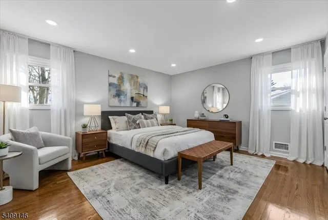 a bedroom with a bed a couch and dresser