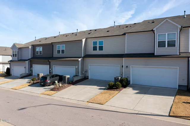 a view of a building with many windows and a table and chairs