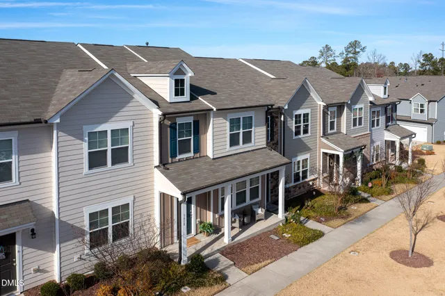 a view of a house with wooden fence