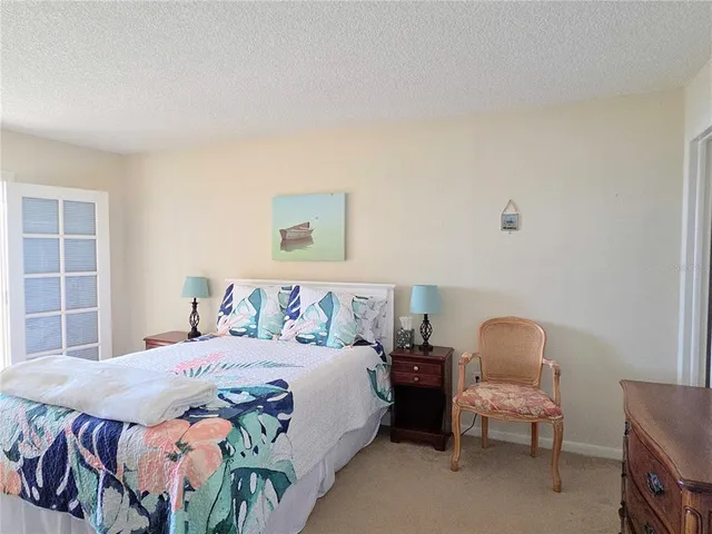 a bed room with a bed and a television