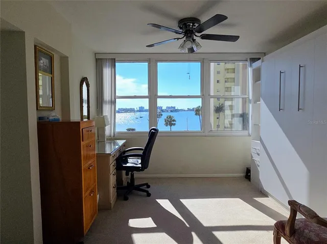 a view of hallway with window and cabinet