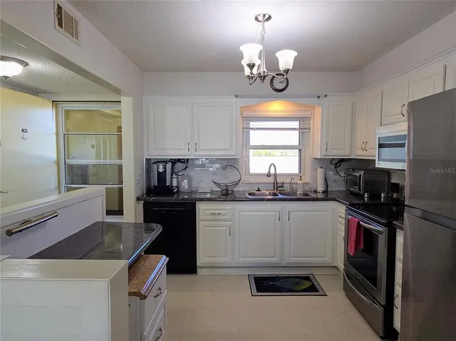 a kitchen with a sink stove and refrigerator