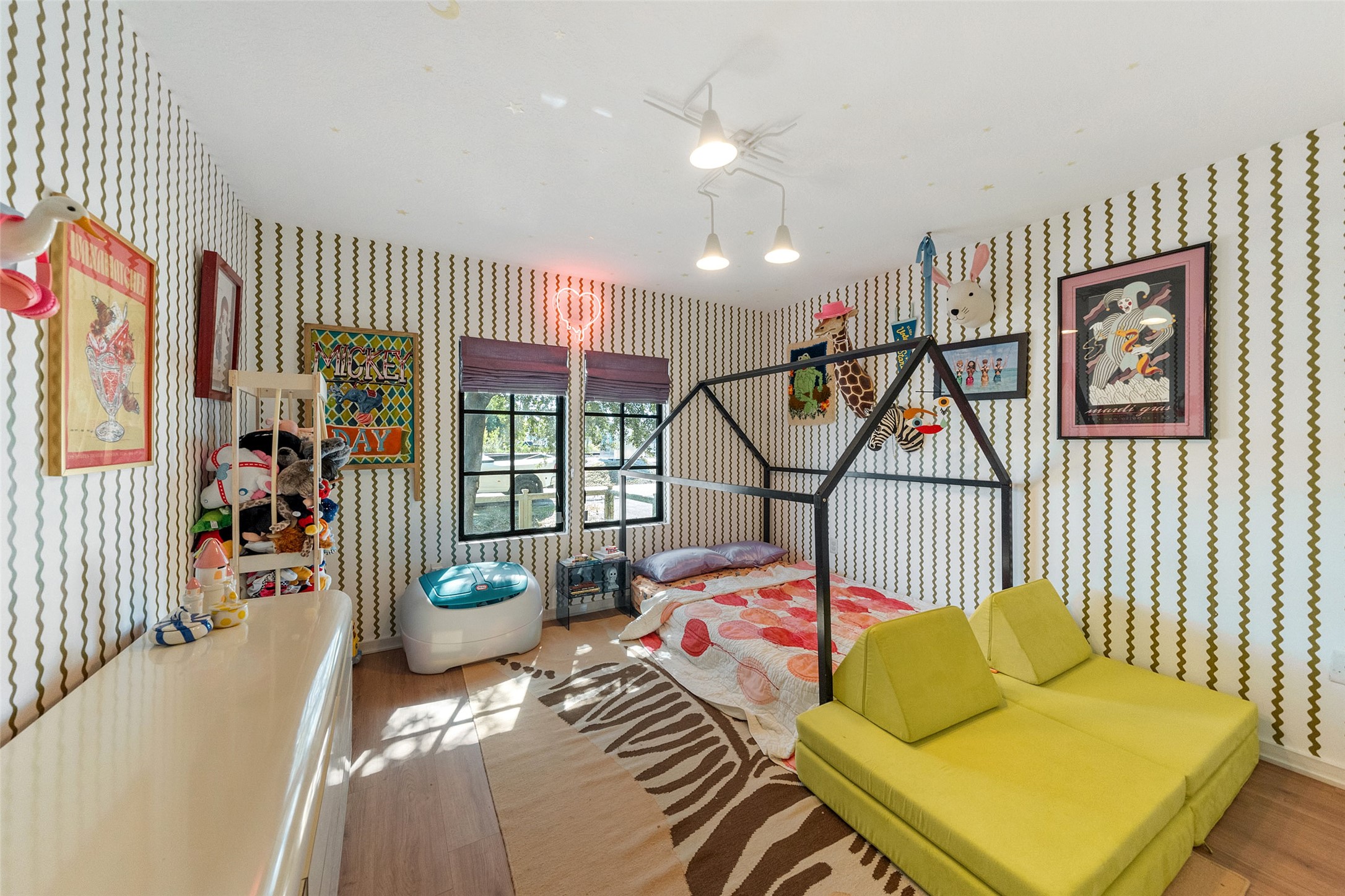 805 East 36th Street Houston, TX 77022 - Photo 19 of 28 a bedroom with a bed and a chandelier