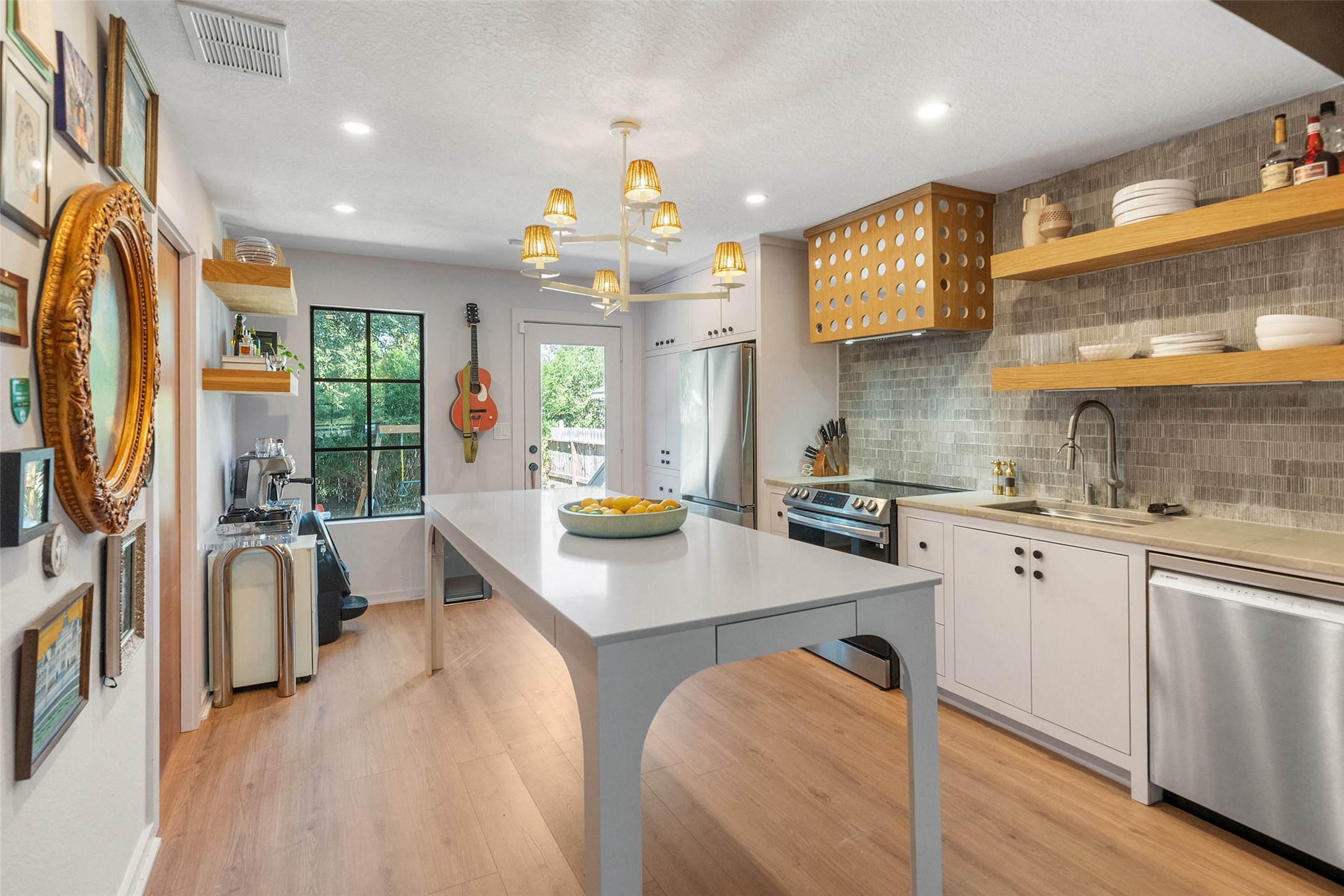 805 East 36th Street Houston, TX 77022 - Photo 7 of 28 a kitchen with stainless steel appliances granite countertop a sink stove and refrigerator