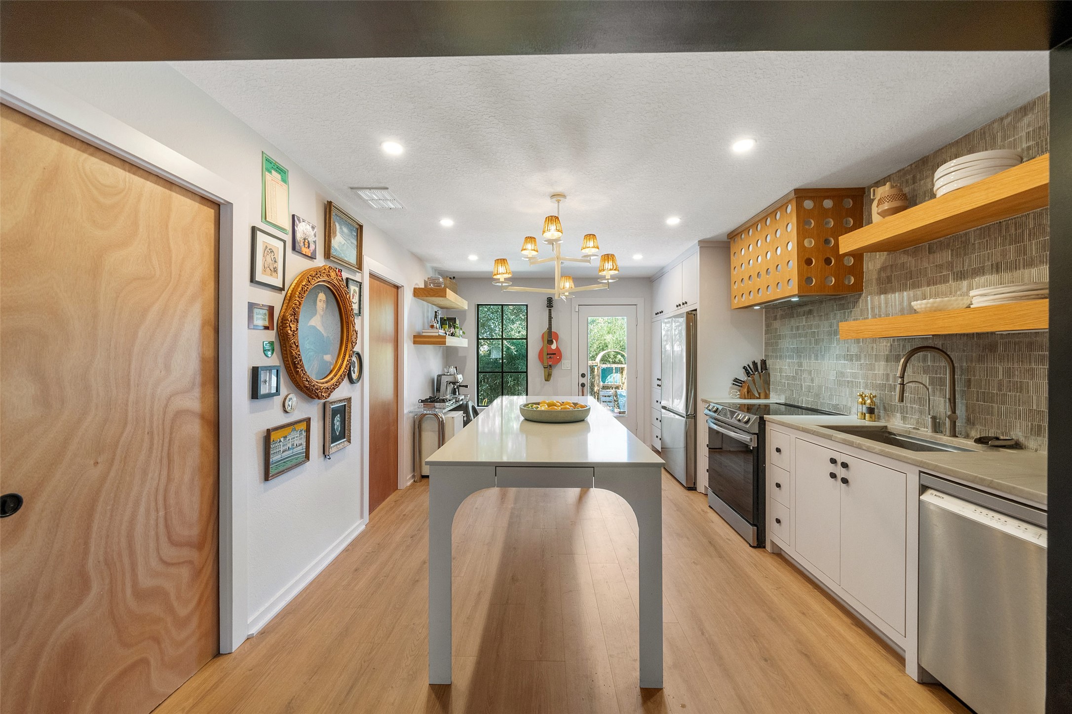 805 East 36th Street Houston, TX 77022 - Photo 8 of 28 a kitchen with stainless steel appliances kitchen island granite countertop a stove and a refrigerator
