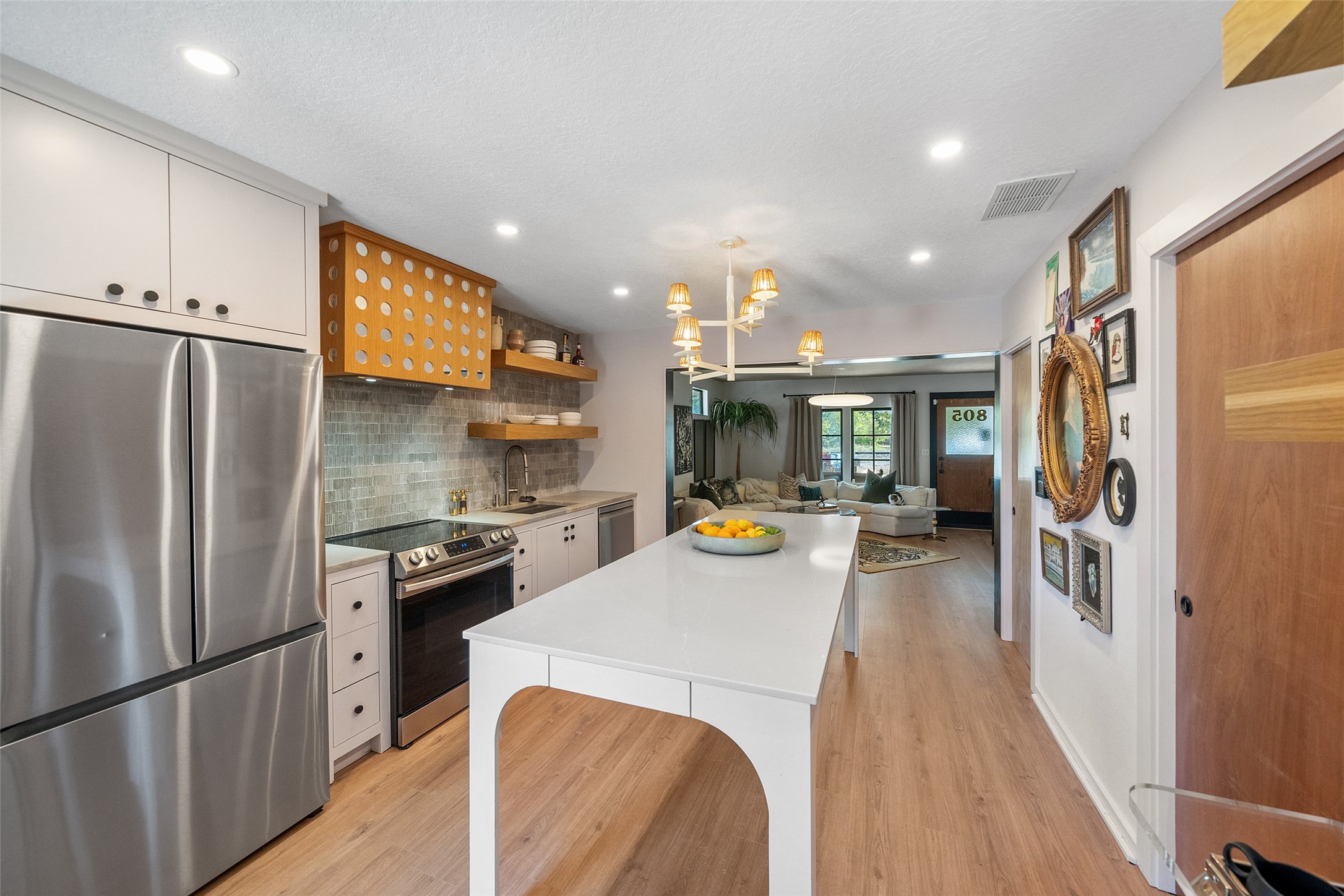 805 East 36th Street Houston, TX 77022 - Photo 10 of 28 a kitchen with stainless steel appliances a refrigerator and a stove top oven