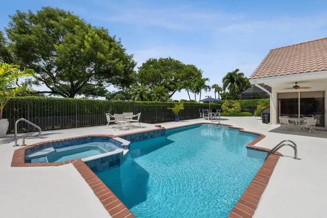 a view of a house with swimming pool and sitting area