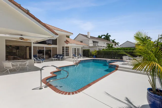 a house with swimming pool in front of it
