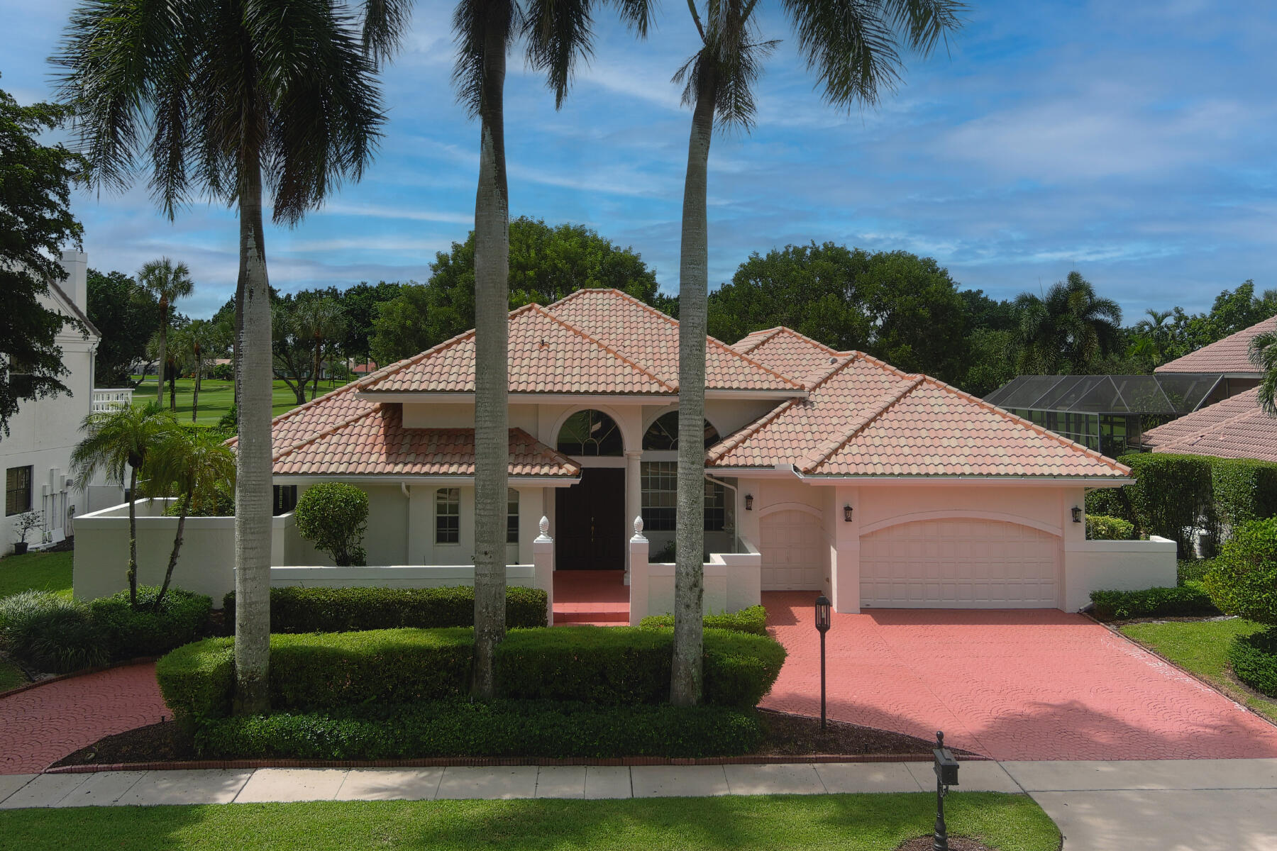 10403 Stonebridge Boulevard Boca Raton, FL 33498 - Photo 26 of 51 a front view of a house with a garden and yard