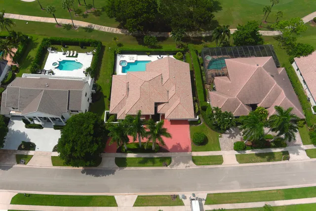 an aerial view of a house with a yard