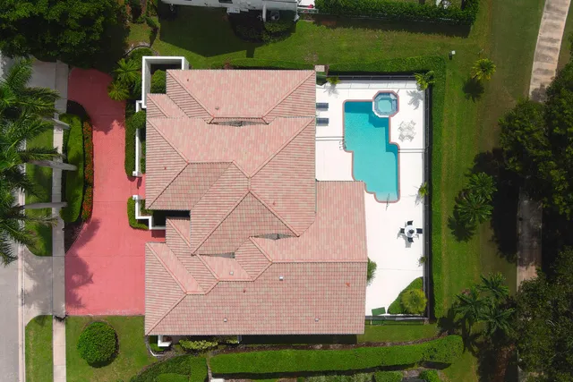 an aerial view of a house with a yard