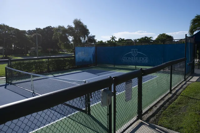 a front view of a house with swimming pool having outdoor seating