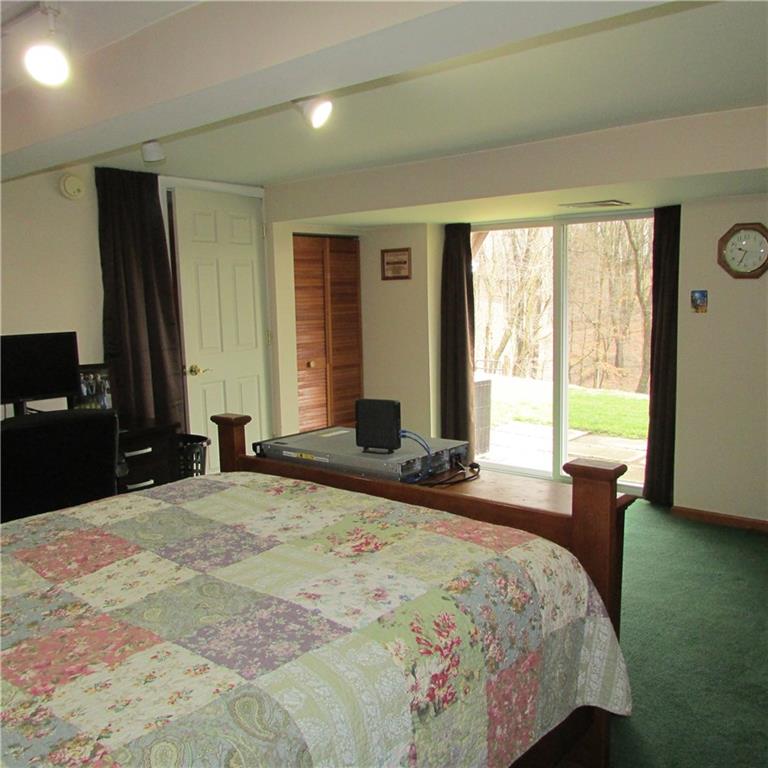331 Wilson Road Clinton, PA 15026 - Photo 14 of 25 Lower level bedroom with slider glass doors to rear yard. Full bath. Spacious room.