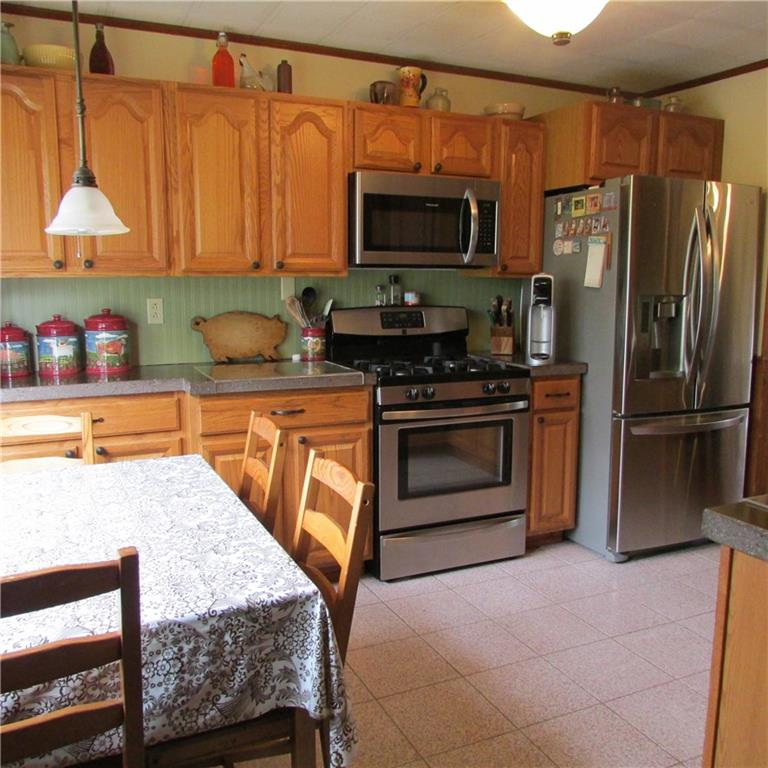 331 Wilson Road Clinton, PA 15026 - Photo 3 of 25 Eat in kitchen. Ceramic tile floor. Stainless steel appliances. Custom concrete counter tops. Wood cabinetry.