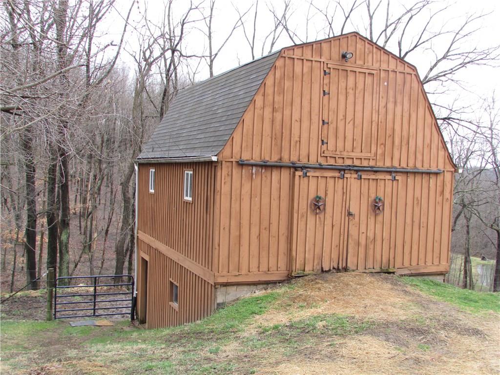 331 Wilson Road Clinton, PA 15026 - Photo 22 of 25 Solid built barn with 3 floors. 2 stalls in lower level. Hay loft in top. Storage and workshop on main floor. Stairs to lower level from main floor. Water, electric and wired video in barn.