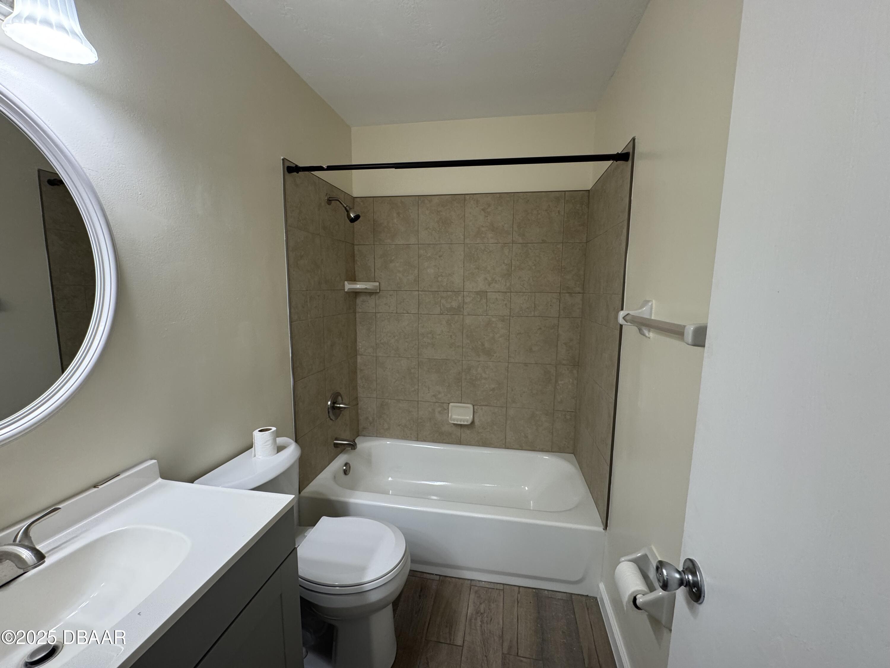 980 Canal View Boulevard, Unit E5 Port Orange, FL 32129 - Photo 7 of 10 a bathroom with a sink a toilet and a bathtub