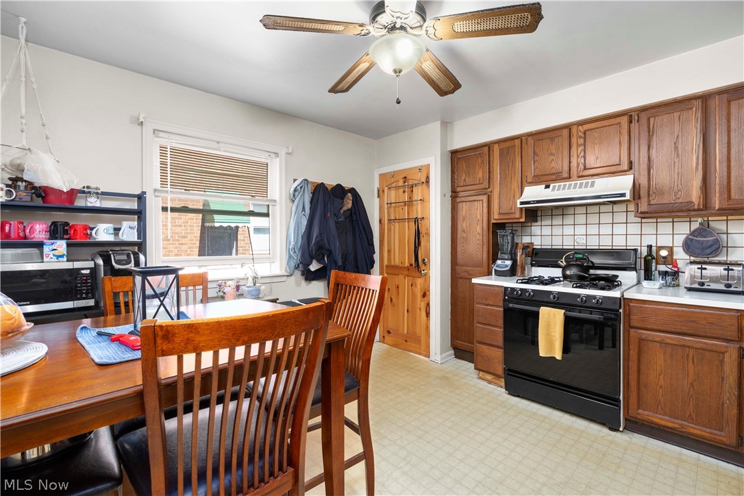 3305 Warren Road Cleveland, OH 44111 - Photo 19 of 28 Kitchen with light tile flooring, ceiling fan, tasteful backsplash, and gas range gas stove