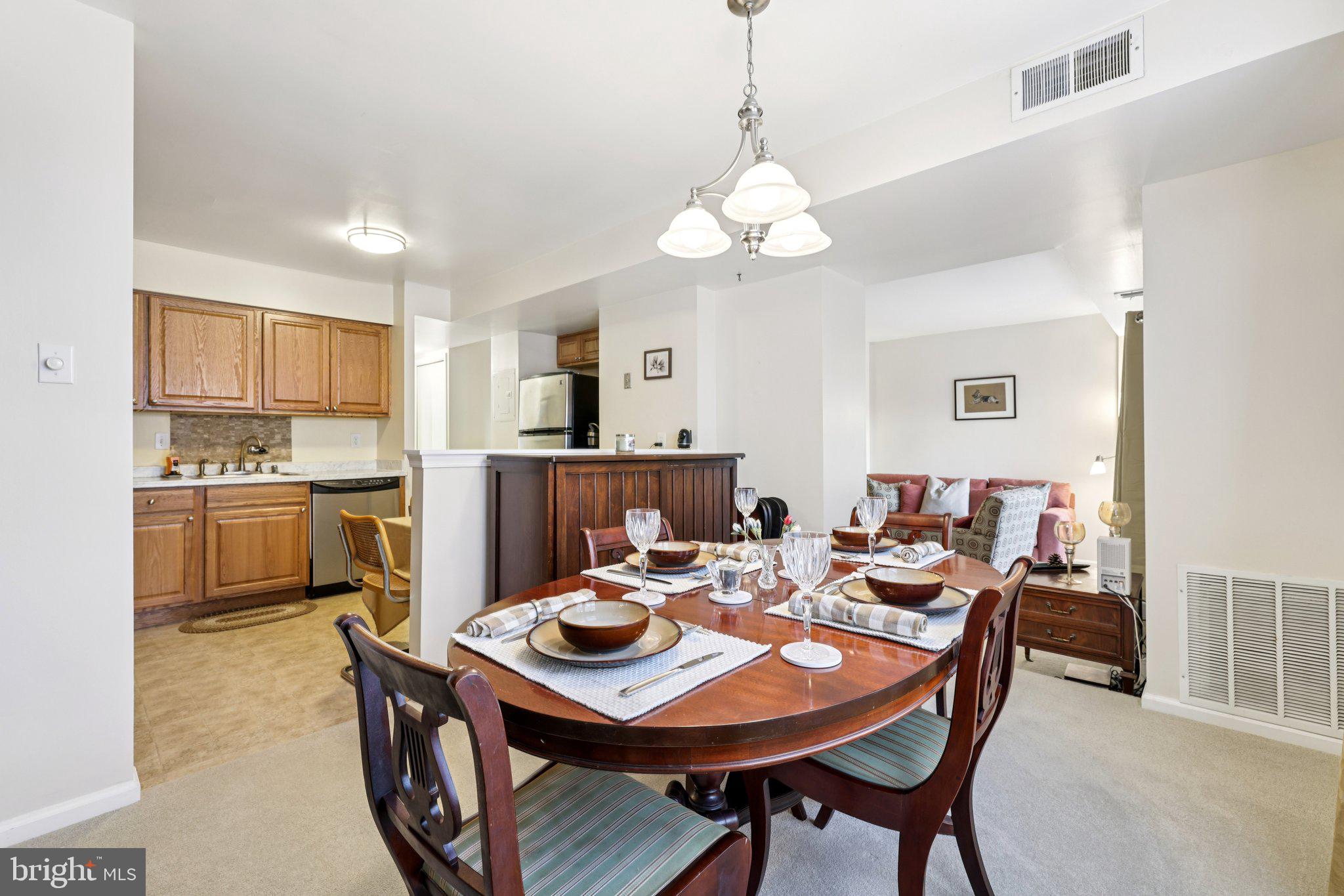 13 Pickering Court, Unit 1302 Germantown, MD 20874 - Photo 16 of 50 a view of a dining room with furniture