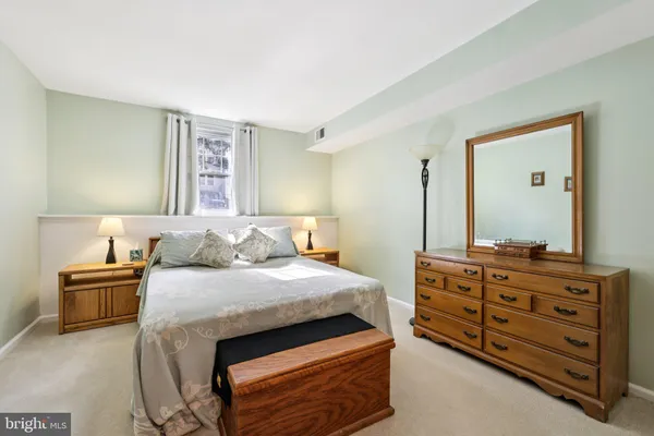 a bedroom with a bed and a dresser